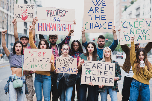 Stock photo of climate change protesters with signs